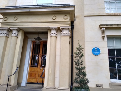 Blue plaque by the front door.